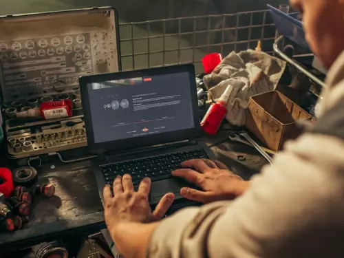a farmer working on MyKUHN on his computer