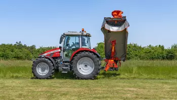 The GMD 3515 disc mower folded at 125° in transport position, on a grassland path