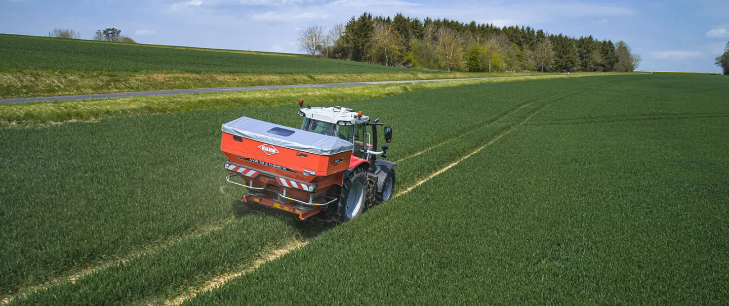 AXIS 50.2 fertiliser spreader at work in a wheat field