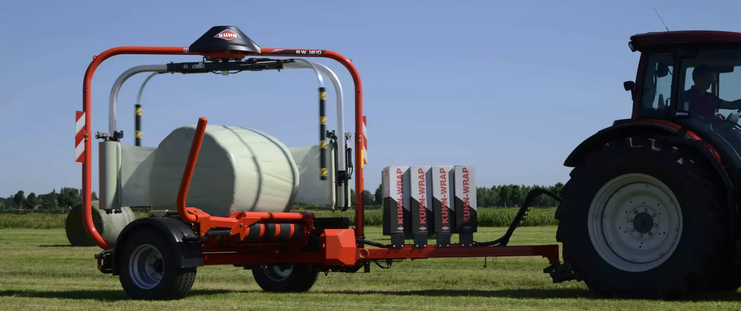 RW 1800 round bale wrapper wrapping bales in a field.