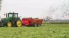 Side view of SL 124 spreading manure in a field.