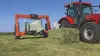 SW 4014 wrapping a square bale with in front of the tractor a square bale